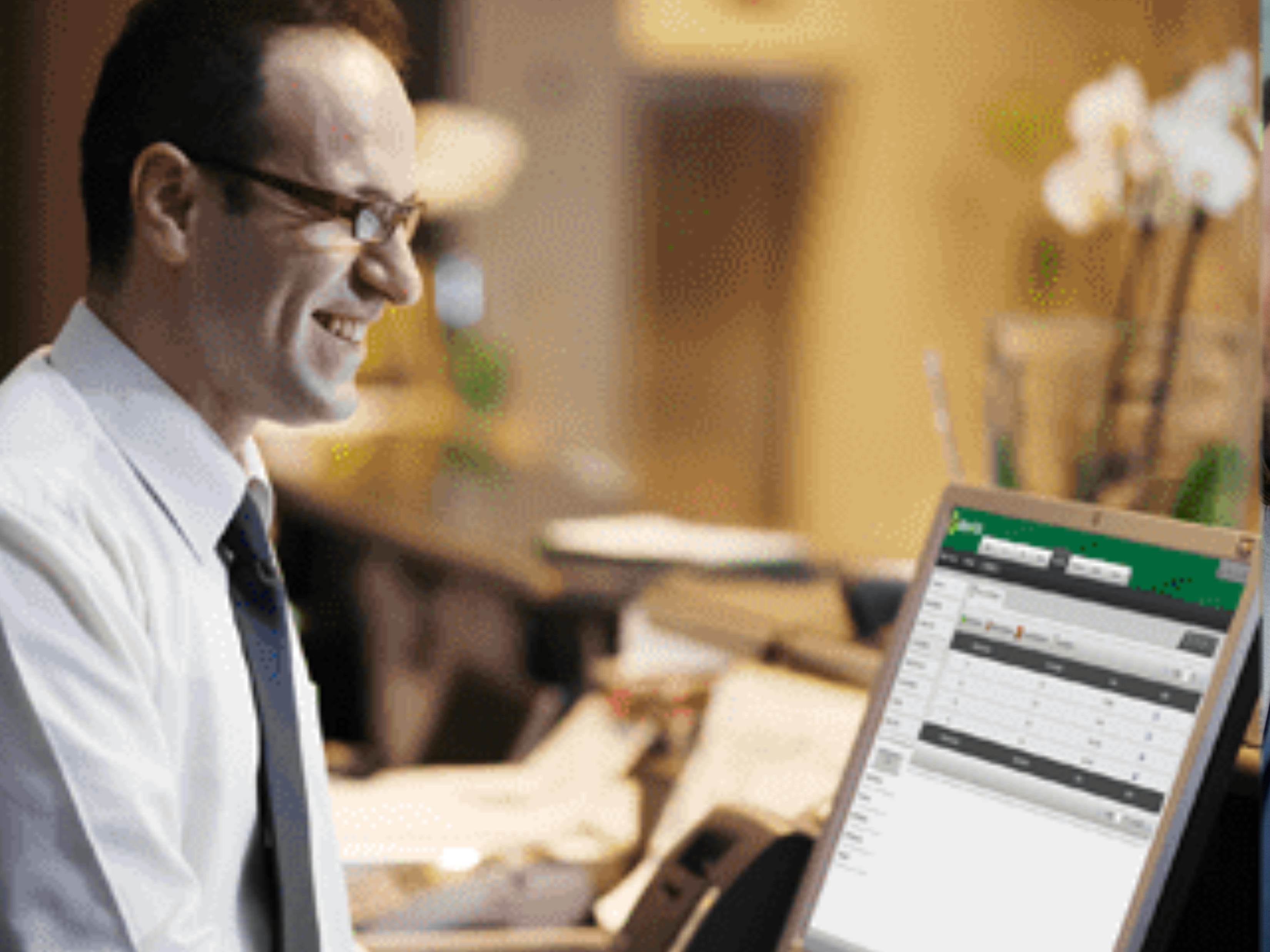 Man working on a laptop in a cozy office environment.